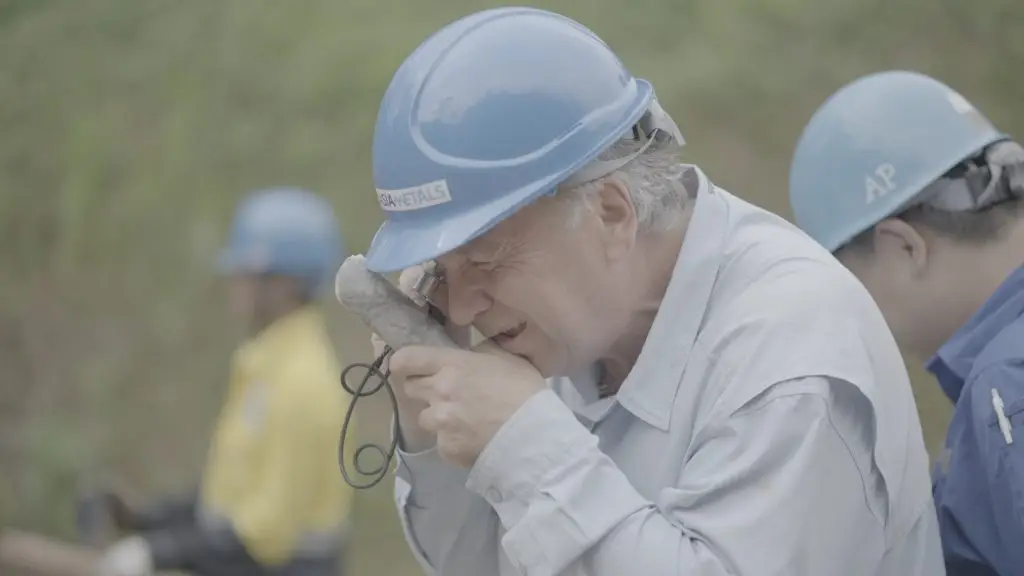 Chief Geologist, David Hobby, examines a Pegamatite Sample